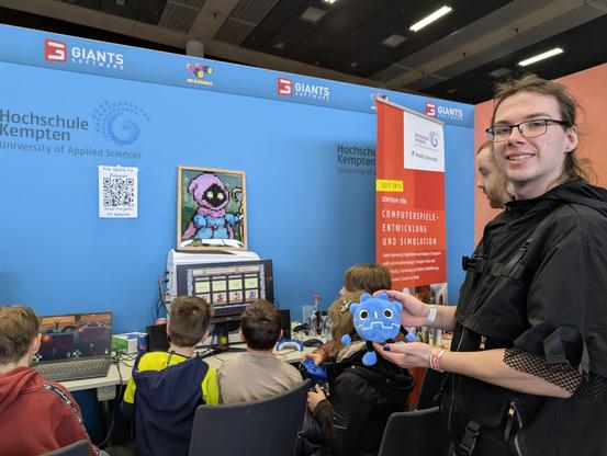 Game called Friendship Runed, Godot plush held up by a developer