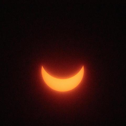 Partial solar eclipse that looks like a yellow glowing smile