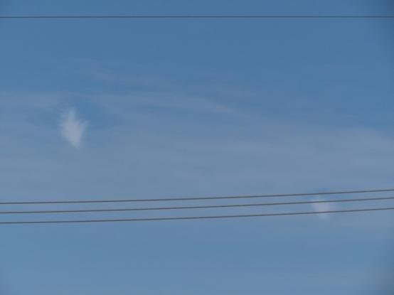 Wider view, showing a second more distant cone shaped cloud similar to the one in the previous image, partially obscured by power lines