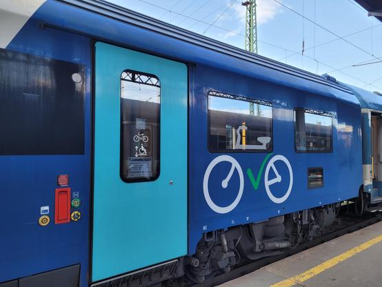 Modern carriage seen from the outside with a big bicycle logo.