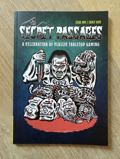 Cover of "Secret Passages," Issue No. 1, early 2025. Features bold illustrations of grotesque characters and fantasy elements, celebrating classic tabletop gaming.