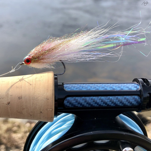 A pink-white baitfish imitation on the handle of the Scott Wave rod.