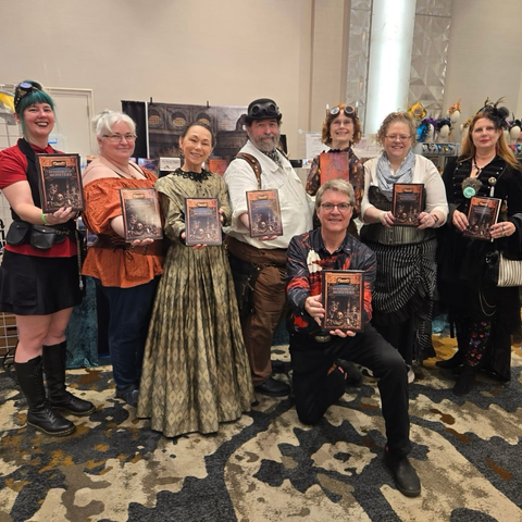 Authors of “An Assembly of Monsters” holding up copies of the book.