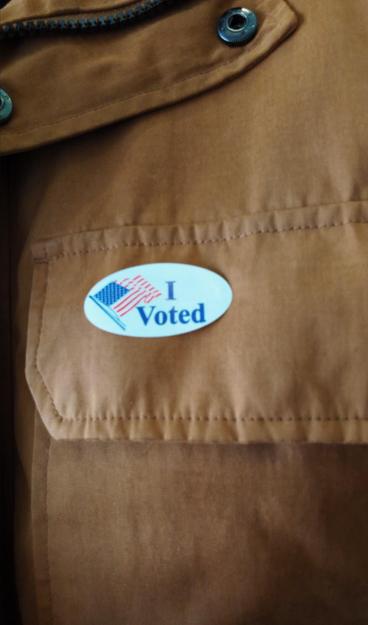 I voted sticker on tan jacket. USA elections