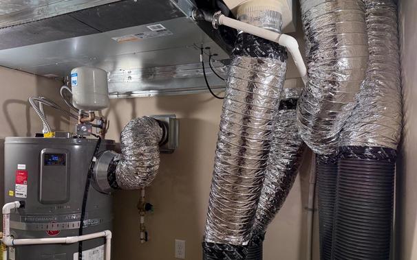 Mini-split air handler top left, ventilation ducts on the right, heat pump water heater bottom left.