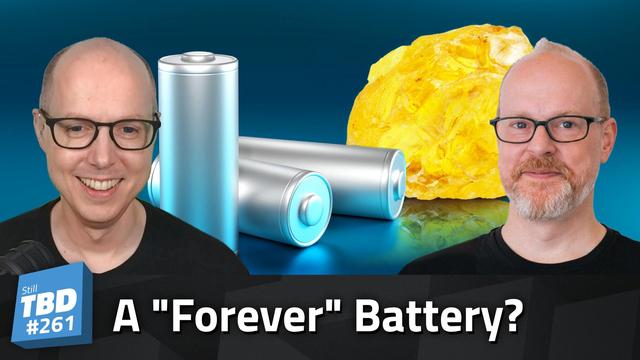 Matt and Sean Ferrell in front of a sulfur crystal and several battery models