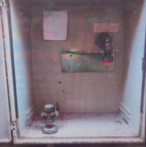 Empty utilities box, with capped pipes bottom left and top-right.