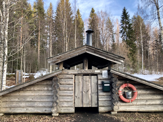 A wooden shelter in the forest.