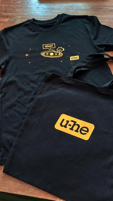 A couple of black t-shirts with orange u-he logo.