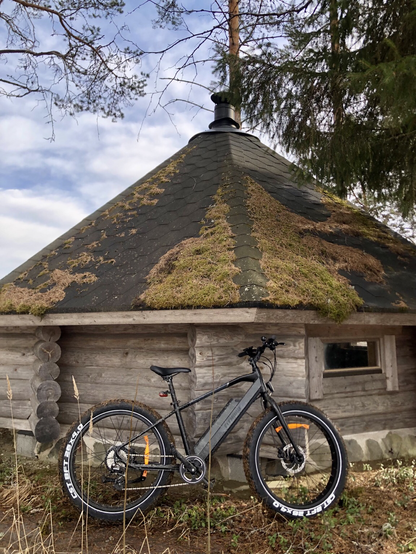 An e-MTB leaning on a kota hut.
