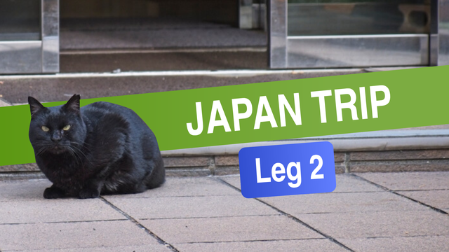 header image for my Patreon post.  It is a photograph of a black cat loafing in front of a door with the text "Japan Trip: Leg 2" next to it.