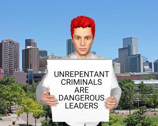 Man holds sign: Unrepentant criminals are dangerous leaders.