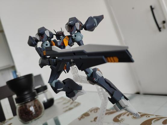 Pharact Gundam model finished facing forward while wielding his sniper rifle formed by joining his two small guns, it is in flying position searching for his target.