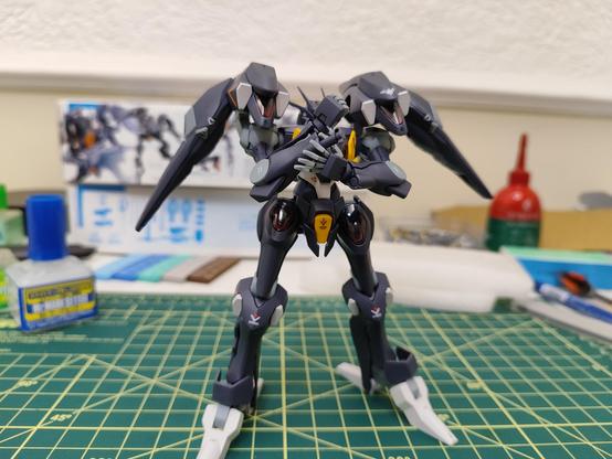 Pharact Gundam standing and preparing his beam saber that is hidden behing Its arm.