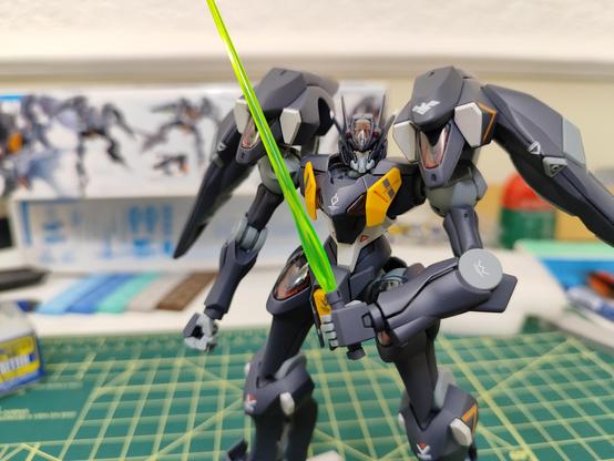 Pharact Gundam standing and with his beam sable ready .