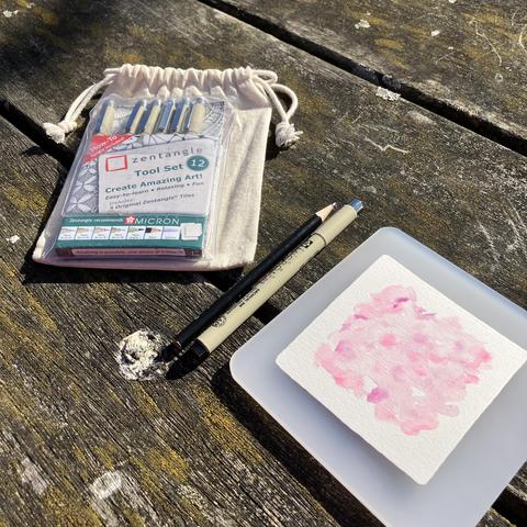 Zentangle materials on a picnic bench in the park