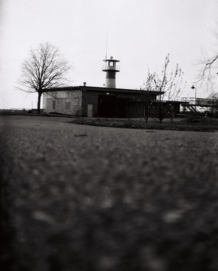 A black and white photo of a light house.