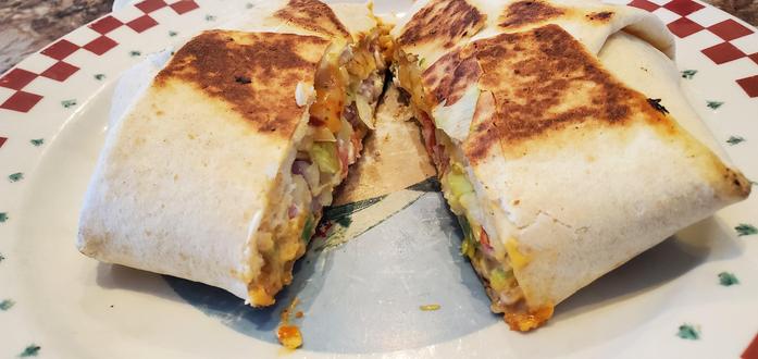 The wrap cut in half on a plate showing the inside of the wrap