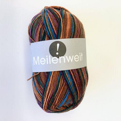 A ball of yarn in various browns, as well as purple and some turquoise on a white background.