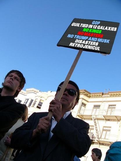professional protestor Frank Chu holding a sign edited to say:
GOP
GUILTIED IN 12 GALAXIES
NO KINGS
NO MASTERS
NO TRUMP AND MUSK
DISASTERS
RETROJENICUL