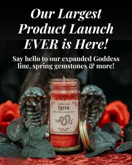 A mini jar candle is in the center of the frame. The wax is red and the label reads, "Goddess Candle / Lilith" with a snake illustration. The text reads, "Our Largest Ever Product Launch EVER is Here! Say hello to our expanded Goddess line, spring gemstones, and more! Presented by Inked Goddess Creations.