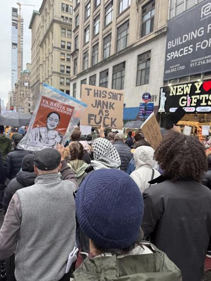 Protester with a homemade sign that read “This Shit Jank as Fuck”
