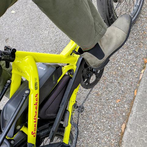 A photo of my right foot on the pedal of a 

yellow Tern HSD cargo bike with its name, Sunstreaker, in red on the seat stay

I'm wearing

grey captoe chelsea boots under an olive green pantleg.
