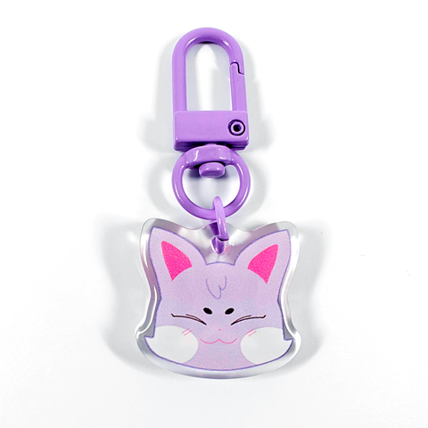A picture of an acrylic keychain of San's Aniteez animal from the K-Pop group ATEEZ. It's the head of the cat smiling like his original design. The rim of the keychain is clear. It has a purple clasp.