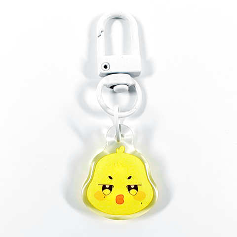 A picture of an acrylic keychain of Mingi's Aniteez animal from the K-Pop group ATEEZ. It's the head of the chick pouting like his original design. The rim of the keychain is clear. It has a white clasp.