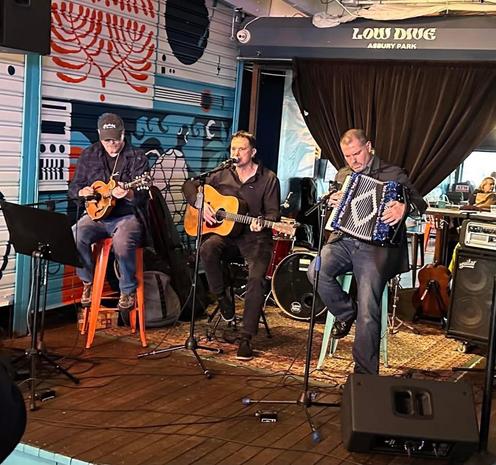 Photo of (left to right) Gorgo on mandolin, Christian Beach on vocals and acoustic guitar, and Brian Kelley on accordion performing at the Low Dive in Asbury Park, NJ, on April 6, 2025. Photo courtesy of Karen Mansfield via Facebook.
