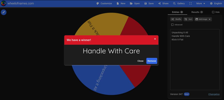 An image with Unpacking It All, Handle With Care, and Klik It Flat in thirds around a wheel as options. Handle With Care won as noted by a message popup.