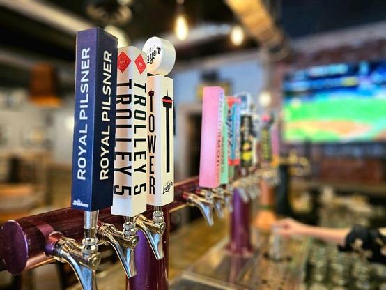 A variety of beers behind a bar.