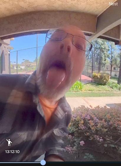 Sticking my tongue out at my smart doorbell. 