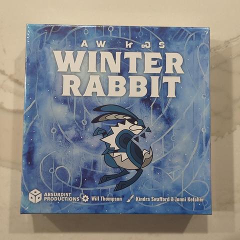 boardgame box in blue and white featuring an artistic rabbit and a bit of Cherokee lettering