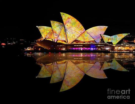 24th May 2014 I went into the City of Sydney to view firsthand the spectacular VIVID SYDNEY 2014, a festival of light, music and ideas. This image is one of my long exposure photographs of the bright and colorful projections of light and patterns on the Sydney Opera House. These colorful projections were continuously changing making Sydney Harbour look like a piece of art.
Many of the ferries also had colorful lighting which just added to the bright and happy atmosphere created by this festival.

Coloring the city with creativity and inspiration, Vivid Sydney highlights include the hugely popular immersive light installations and projections; Vivid Aquatique immersive water theatre; performances from local and international musicians at Vivid LIVE at Sydney Opera House and the Vivid Ideas Exchange featuring public talks and debates from leading global creative thinkers.  

Link - https://kaye-menner.pixels.com/featured/vivid-sydney-2014-opera-house-6-by-kaye-menner-kaye-menner.html
