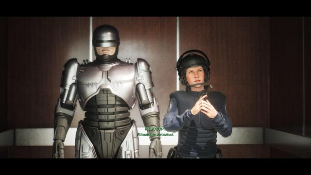 A humanoid robot in a metallic suit stands alongside a woman in tactical gear, both appearing in an elevator setting. Text on the screen indicates the robot, identified as Robocop, has detected a threat.