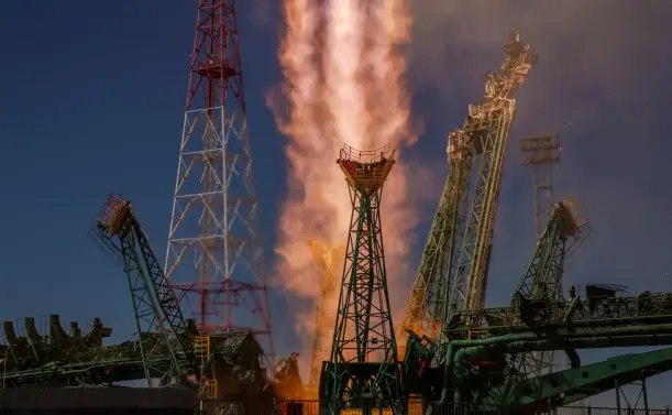 A liftoff on a column of fire, the support towers retreating.
