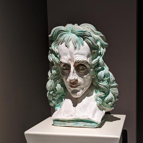 Bust of a demented looking individual with green hair.