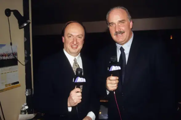 Vintage photo of long-time announcers Sam Rosen and John Davidson calling the play-by-play for the New York Rangers hockey team. Photo via NYPost