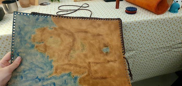 Me lacing the veg tan leather tooled map of Middle-Earth during a craft fair