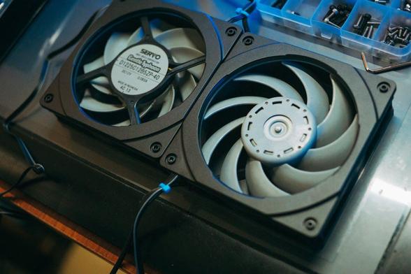 Two cooling fans positioned on top of a computer tower, showcasing their design and placement for optimal airflow