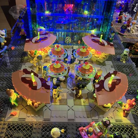 Overhand shot of the food court with four different stalls in each corner and four standing tables in the middle of the square