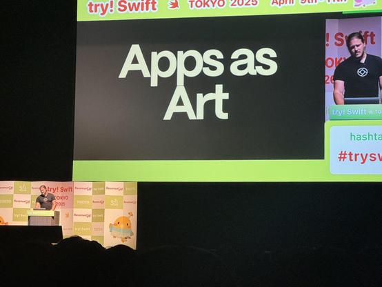 SDW on stage presenting - a slide in the background reads ‘apps as art’ 