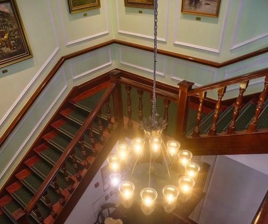 A view of the ornate staircase inside the old courthouse, showcasing its historical architecture and intricate railings