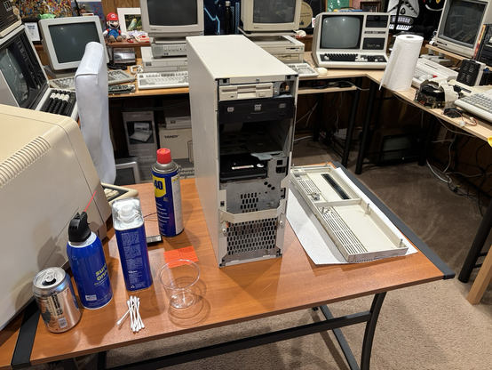 Unspecified Tandy computer, partially disassembled, with cleaning products nearby.