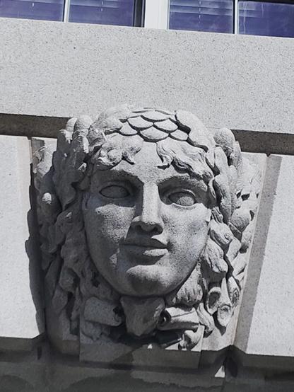 Building detail sculpture of a woman's head 