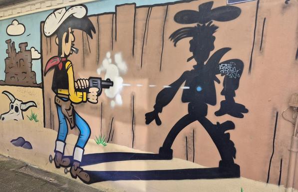 Streetart an einer Hauswand in Schleswig: Lucky Luke, der Mann, der schneller zieht als sein Schatten.