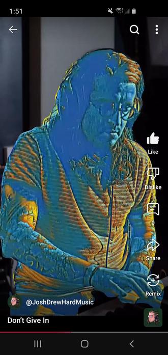 A music producer jamming on a midi controller, the visual is distorted orange and blue, the producers glasses and tattoos shining