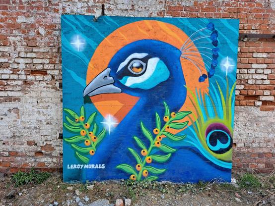A smaller artwork, showing a peacock's head outlined by the sun