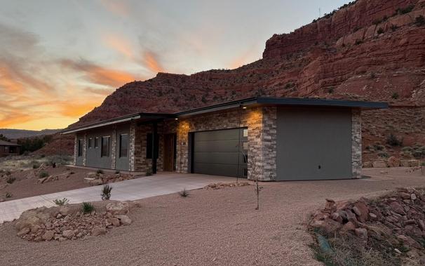 Our vacation home in Kanab as seen from the southeast, with a cliff and sunset colors in the background.